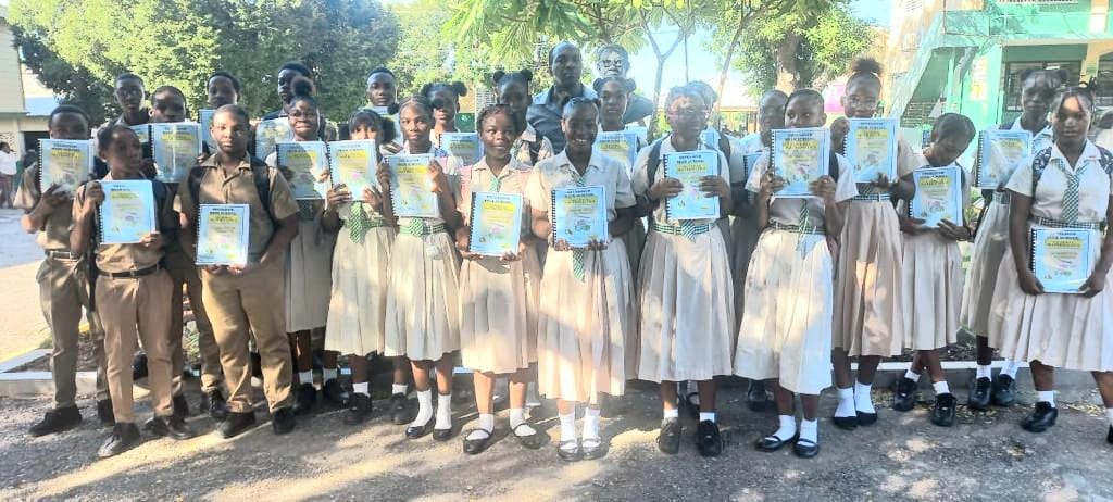 Grade 9 students proudly display their Maths Workbooks sponsored by the Class of 81